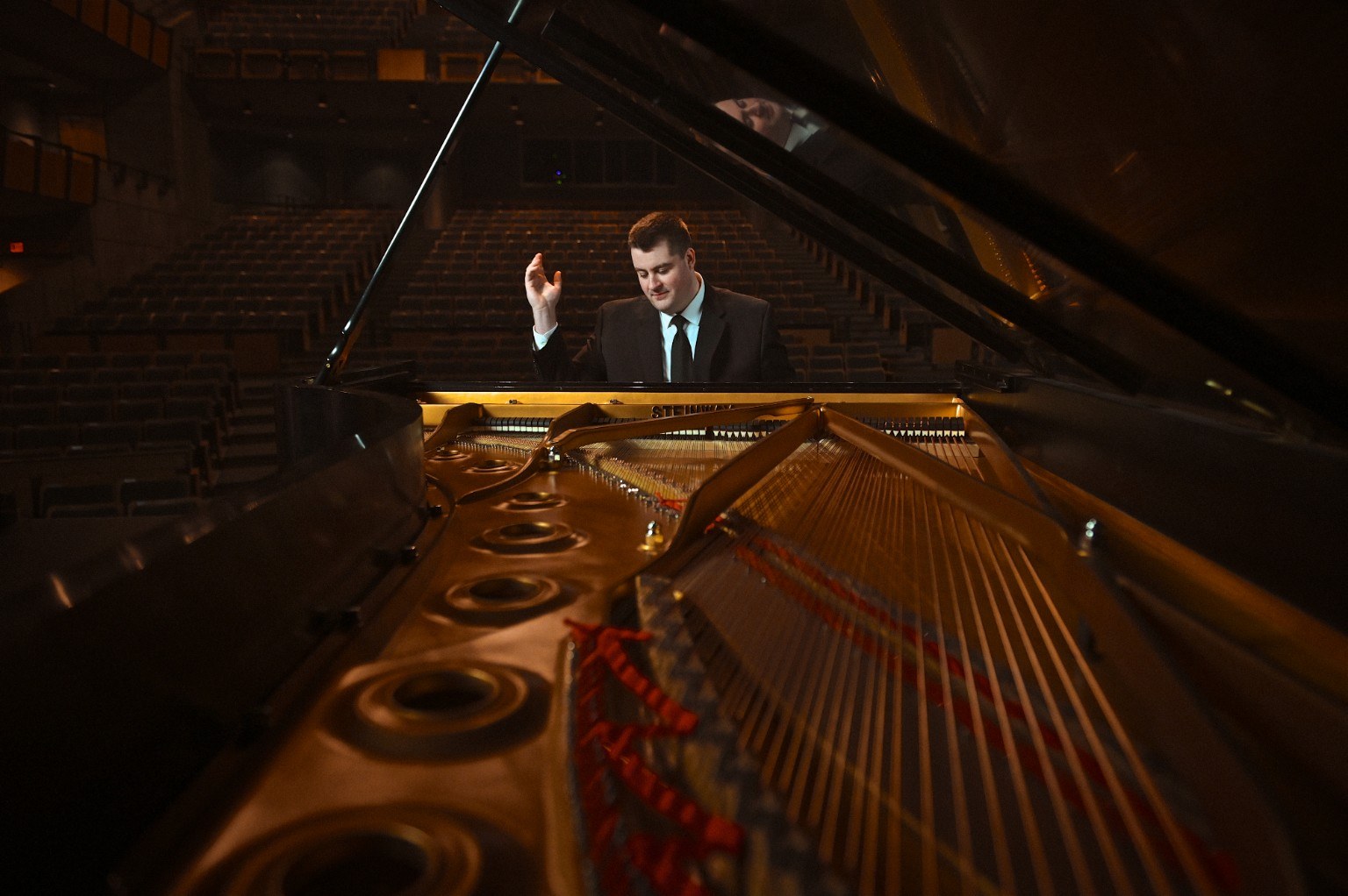 Scott Arkell seated at a grand piano